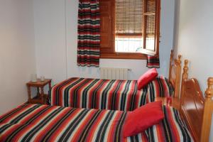 a bedroom with two beds and a window at Apartamentos Rurales Rosendo: "El Laurel" in Capileira