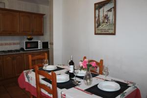 a dining room table with plates and flowers on it at Apartamentos Rurales Rosendo: "El Laurel" in Capileira