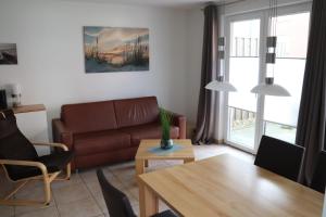 a living room with a couch and a table at Sylt-Sonne-Meer in Rantum