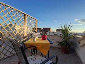 a yellow table and chairs on a balcony at Apartment Place 2 Stay in Hvar