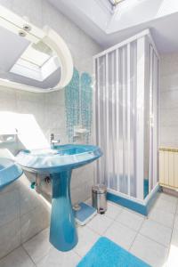 a bathroom with a blue sink and a window at Moonshine apartment with magnificent view in Šibenik