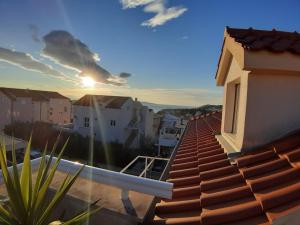 a view from the roof of a house with the sunset at Apartment Place 2 Stay in Hvar