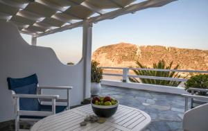 a bowl of fruit sitting on a table on a patio at Agia Kyriaki Studios in Agia Kiriaki Beach