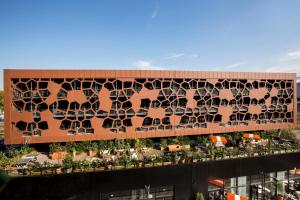 an exterior view of a building with lots of windows at MOB HOTEL Lyon Confluence in Lyon