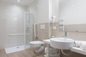 a bathroom with a toilet and a sink and a shower at Hotel Mediterraneo in Sottomarina