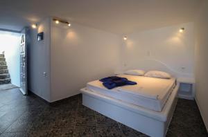a white bedroom with a bed in a room at Agia Kyriaki Studios in Agia Kiriaki Beach