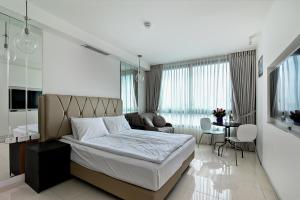 a bedroom with a bed and a living room at Netanya SeaView ApartHotel in Netanya
