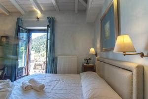 Posteľ alebo postele v izbe v ubytovaní Ostra Menalon Luxury Suites