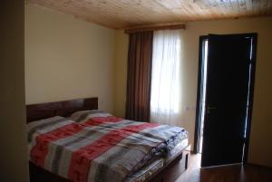Postel nebo postele na pokoji v ubytování Gogi Jafaridze's Guesthouse