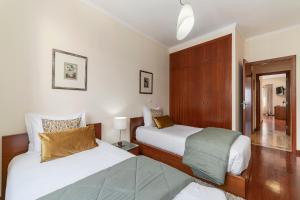 a hotel room with two beds at Ajuda III by An Island Apart in Funchal