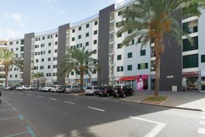 a street with cars parked in front of a building at Ajuda III by An Island Apart in Funchal