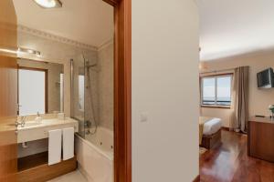 a bathroom with a sink and a mirror at Ajuda III by An Island Apart in Funchal +18 photos