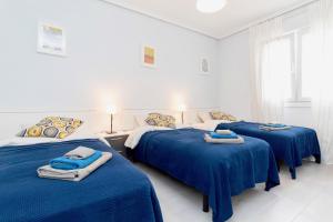 A bed or beds in a room at Luxury La Zenia Beach Apartment