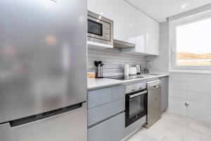 A kitchen or kitchenette at Luxury La Zenia Beach Apartment