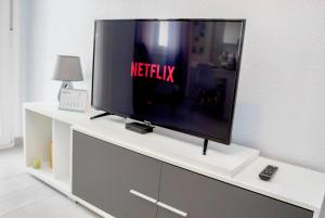 A television and/or entertainment centre at Luxury La Zenia Beach Apartment Még 25 kép