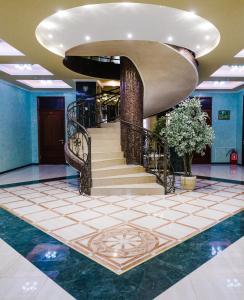 a lobby with a spiral staircase in a building at Donskaya Riviera Hotel in Rostov on Don