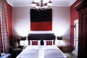 a red bedroom with two beds and a chandelier at Hotel Alt Nürnberg in Hamburg