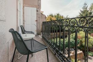 a balcony with a table and chairs on a building at Rosa Et Al Townhouse in Porto