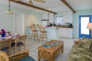 a kitchen and living room with a table and chairs at Coconut Coast Villas in Contant