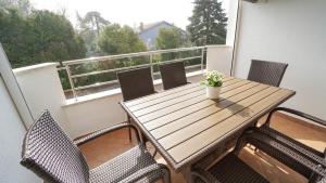 a wooden table and chairs on a balcony at Apartment Sandy Beach Zambrattia in Zambratija