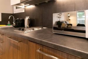 a kitchen with a counter top with a microwave at TONI'S Cute 2BD Apartment in Koukaki! in Athens