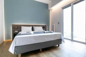 a bedroom with a large bed and a large window at TONI'S Cute 2BD Apartment in Koukaki! in Athens +4 photos