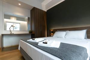 a bedroom with a large bed with towels on it at TONI'S Cute 2BD Apartment in Koukaki! in Athens