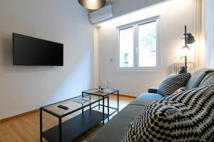A television and/or entertainment centre at TONIS Le Petit Nicolas 1BD Apartment in Koukaki!
