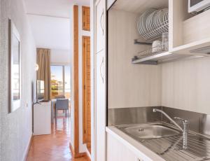a kitchen with a sink and a table at Dom Pedro Lagos in Lagos