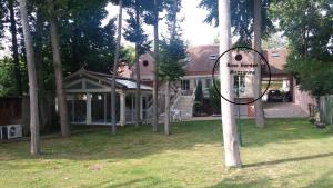 a house with a sign in the front yard at Rose Garden Mezzanine in Giverny