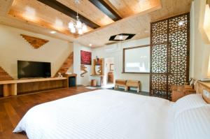 Una cama o camas en una habitación de ChunYang Homestay春陽一品居