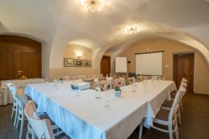 a conference room with tables and chairs and a screen at Kúria Beckov - Penzión in Beckov +56 photos