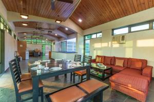 a living room with a table and a couch at SaffronStays Bellini, Karjat in Kalamb +18 photos