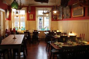 a restaurant with wooden tables and chairs in a room at Hotel Lili Marleen in Travemünde