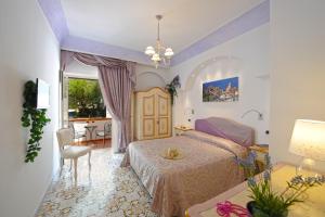 En eller flere senge i et værelse på Hotel La Conchiglia