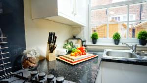 a kitchen with a sink and a counter with vegetables on it at The Storyhouse Gathering in Chester