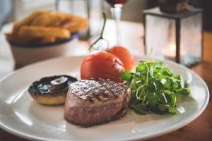 a plate of food with meat and vegetables on a table at Hope & Anchor in Hope Cove