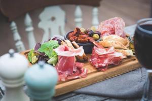 a wooden plate of food on a table at Hope & Anchor in Hope Cove
