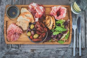 a plate of food with meat and vegetables on a cutting board at Hope & Anchor in Hope Cove