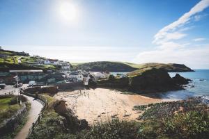 a view of a beach with houses and the ocean at Hope & Anchor in Hope Cove