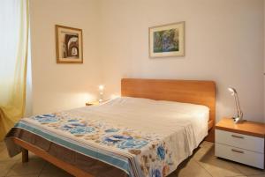 a bedroom with a bed and a lamp on a table at Da Simona Appartamenti in Imperia