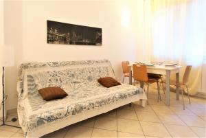 a bedroom with a bed and a table with chairs at Da Simona Appartamenti in Imperia