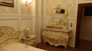a bedroom with a bed and a mirror on a table at Dom Pomorski in Miastko