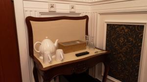 a table with a vase and a remote control on it at Dom Pomorski in Miastko