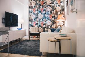 a living room with a white couch and a tv at Urruti Apartment by People Rentals in Bilbao