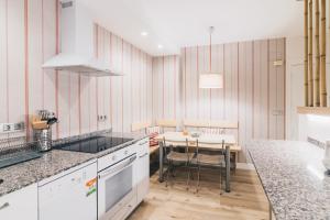a kitchen with a table and a dining room at Urruti Apartment by People Rentals in Bilbao