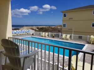 a view from the balcony of a condo with a swimming pool at Surf Side Hotel in Nags Head