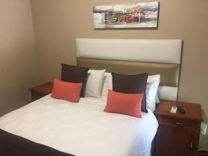a bedroom with a bed with two pillows at DeTlous BnB in Empangeni +24 photos