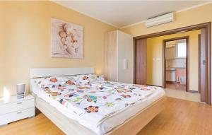 a bedroom with a large bed with a white comforter at Apartments Vea in Pula
