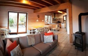 a living room with a couch and a stove at Haus Dürr23 in Lauterbach